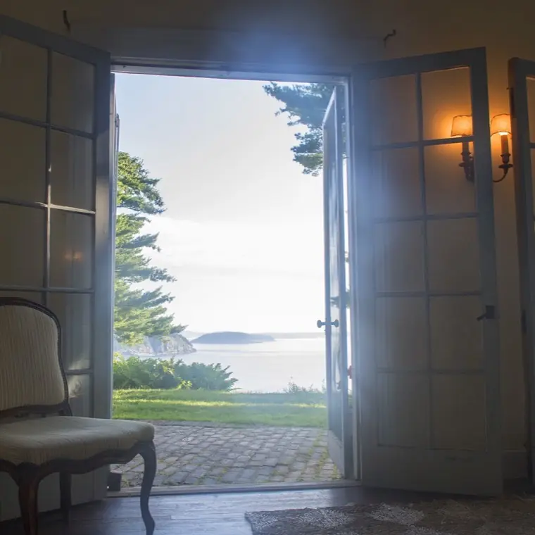 The living room with French doors opening toward the terrace