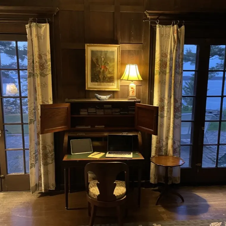 A writing desk beside a window, one of the house&rsquo;s quiet working corners
